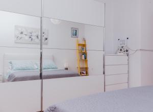 a bedroom with two beds and a mirror at Apartment Tea in Split