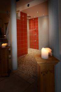 a bathroom with a shower and a candle on a counter at Hotel Lammerts in Horn-Bad Meinberg