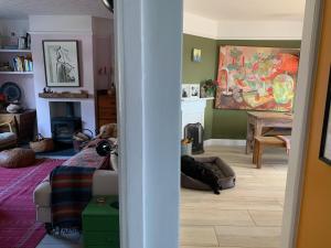 a living room with a dog laying on the floor at Artist's home with views over Bath in Bath