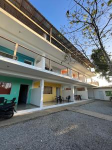an external view of a building with tables at Apartamentos Palo Coco in Las Terrenas