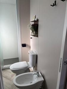 a bathroom with a toilet and a sink at Agricampeggio Cà di Mazza in Monzuno