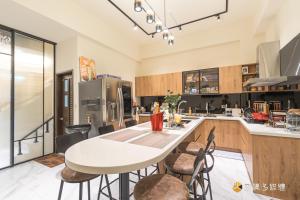 a kitchen with a white table and some chairs at TING ZHU Homestay in Hualien City