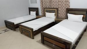 Postelja oz. postelje v sobi nastanitve Hotel Royal Luxury Multan
