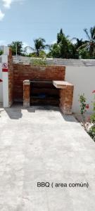 a brick wall with a bench in a courtyard at Beautiful Condo in La Romana with pool near Caleta Beach in La Romana