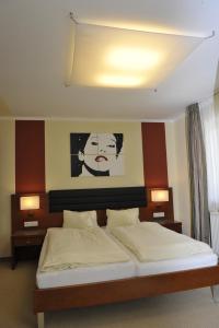 a bedroom with a bed with a painting on the wall at Villa Castelli in Schladming