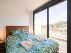 a bedroom with a bed and a large window at Belvilla by OYO Casa Joyosa in Villajoyosa +32 photos