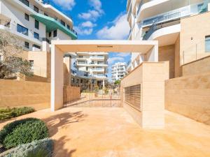 a courtyard with a gate in a building at Belvilla by OYO Casa Joyosa in Villajoyosa