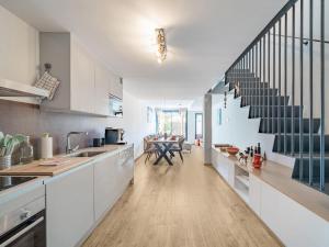 a kitchen with white cabinets and a staircase at Belvilla by OYO Casa Joyosa in Villajoyosa