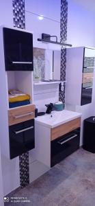 a kitchen with a white counter and a sink at Apartament Szóstka nad Sołą in Czaniec