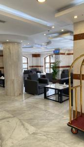 a waiting room with couches and a table at Al Ayniah Hotel in Al Madinah