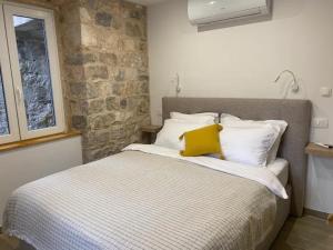 a bedroom with a bed with a yellow pillow on it at Cloe Apartment in Split