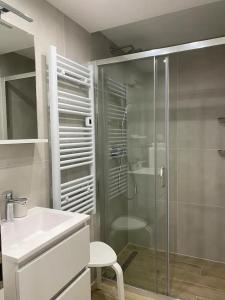 a bathroom with a glass shower and a sink at Cloe Apartment in Split