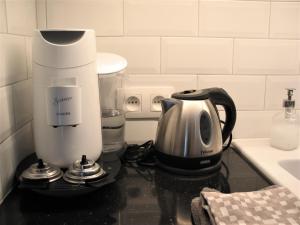 a kitchen with a coffee maker on a counter at Le Baron Apartments in Stavelot