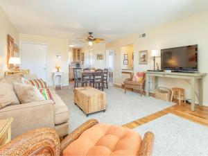 a living room with a couch and a table at Lighthouse Point 4B in Tybee Island