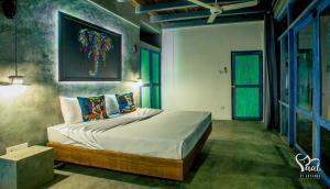 a bedroom with a large bed in a room at Yaal by Aryaana - Villa in Yala in Tissamaharama