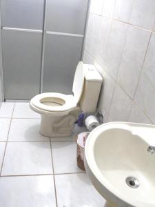 a bathroom with a toilet and a sink at Pousada Residencial Bambus in Florianópolis