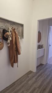 a room with a coat hanging on a wall at BOHO ROOMS MARTA in Priolo Gargallo