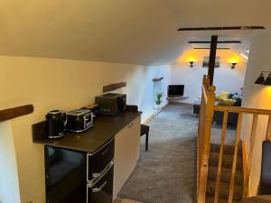 a kitchen and living room with a microwave on a counter at The Barn Behind 1530 in Castleton +12 photos