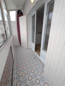 an empty hallway with a tile floor in a house at Appartement avec vue mer in Vaux-sur-Mer