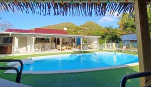a swimming pool in the backyard of a house at La Rose du Bresil Marie-Galante in Capesterre-de-Marie-Galante