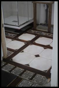 a door to a bathroom with a tile floor at maison d'artiste accès jardin in Maubeuge