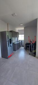 a kitchen with a refrigerator and a table with red chairs at Complejo Junin Dpto Planta Alta in Formosa