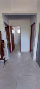 an empty room with a hallway with doors and a tile floor at Complejo Junin Dpto Planta Alta in Formosa
