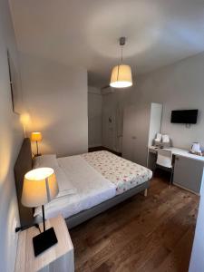 a bedroom with a bed and a desk and a lamp at Infinity Castle in Rome