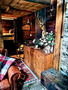a room with a wooden cabin with a bed and a table at Ranch House in Newton Stewart