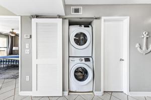a laundry room with a washer and dryer at Spacious Seaside Beach and Racquet 3706 with Pool and Comfort Amenities in Orange Beach
