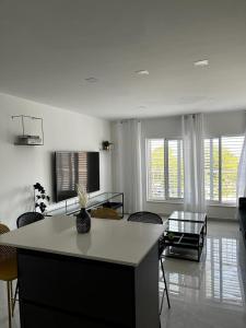a living room with a table and chairs at מישל נופש ,צופית תחתית 6003 in Eilat +50 photos