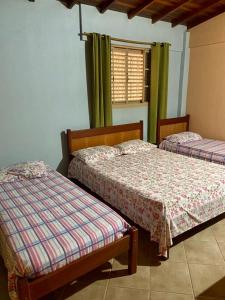 Cama ou camas em um quarto em Pousada Oasis