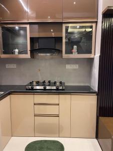 a kitchen with a stove and a counter top at AVVAIRAM SERVICE APARTMENT G8 in Chennai