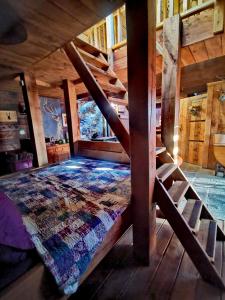 a bedroom with a bed in a wooden cabin at Ranch House in Newton Stewart