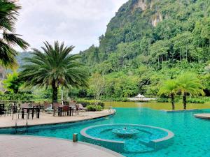 a swimming pool in front of a mountain at Ipoh All Suite Resort, Jalan Haven Ipoh in Ipoh