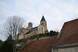 an old church with a steeple on top of roofs at Gites Rural De La Douix in Châtillon-sur-Seine +4 photos