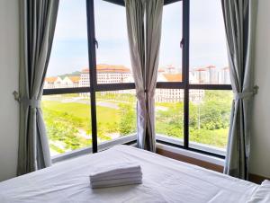 a bedroom with a bed and a large window at Bell Suites by Salaam Suites in Sepang +78 photos