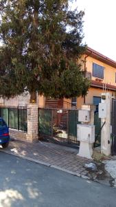 a building with a fence and a tree next to a street at Villa Giulia in Ateleta