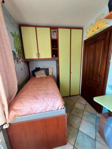 a small bedroom with a bed and yellow cabinets at Villa Giulia in Ateleta