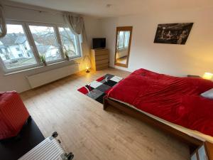 sypialnia z dużym czerwonym łóżkiem w pokoju w obiekcie Ferienhaus Rheinnähe w mieście Lykershausen
