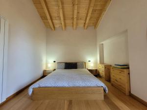 a bedroom with a bed and two lamps on two dressers at Walking's House Mountain Lake Iseo Hospitality in Lovere