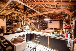 a large kitchen with wooden ceilings and a counter top at Celeiro Guarapuava, 4 quartos, Paz e Tranquilidade in Guarapuava