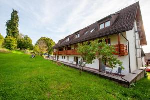 a large white house with a green yard at Hotel Landgasthof Oberschnorrhof in Dammbach