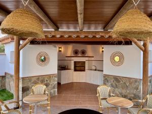 a patio with two tables and chairs and a kitchen at Casa Limon, boutique Bed and Breakfast, Andalucia in Alhaurín el Grande