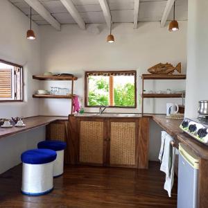 a kitchen with wooden counters and a sink and a window at Belmoz Beach House in Chuca