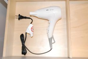 a hairdryer plugged into a hair dryer at Suite avec terrasse, Nancy Thermal, parc Ste Marie in Nancy