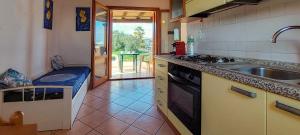 a kitchen with a sink and a stove at Appartamento Residenziale Bilocale Citai San Teodoro in San Teodoro