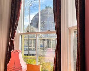 a window with a view of a building at Pavilion View in Buxton