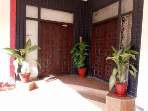 a pair of doors with potted plants in front of them at Hotel Sky Inn Clifton in Karachi