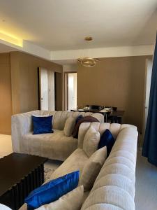 a living room with a large couch and blue pillows at two bedroom in Westland in Nairobi
